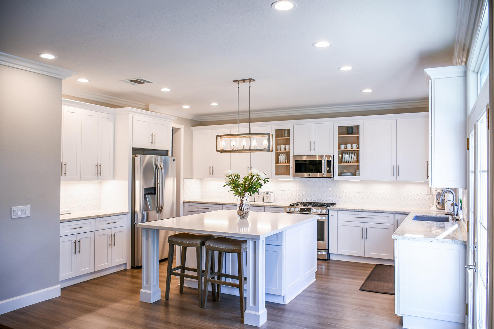 Kitchen with bright lighting and white cabinets
